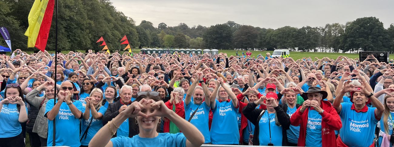 Alzheimer's Society Memory Walk participants forming heart hands