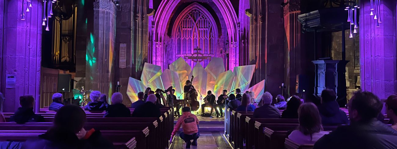 Dramatic performance inside a gothic church with purple lighting