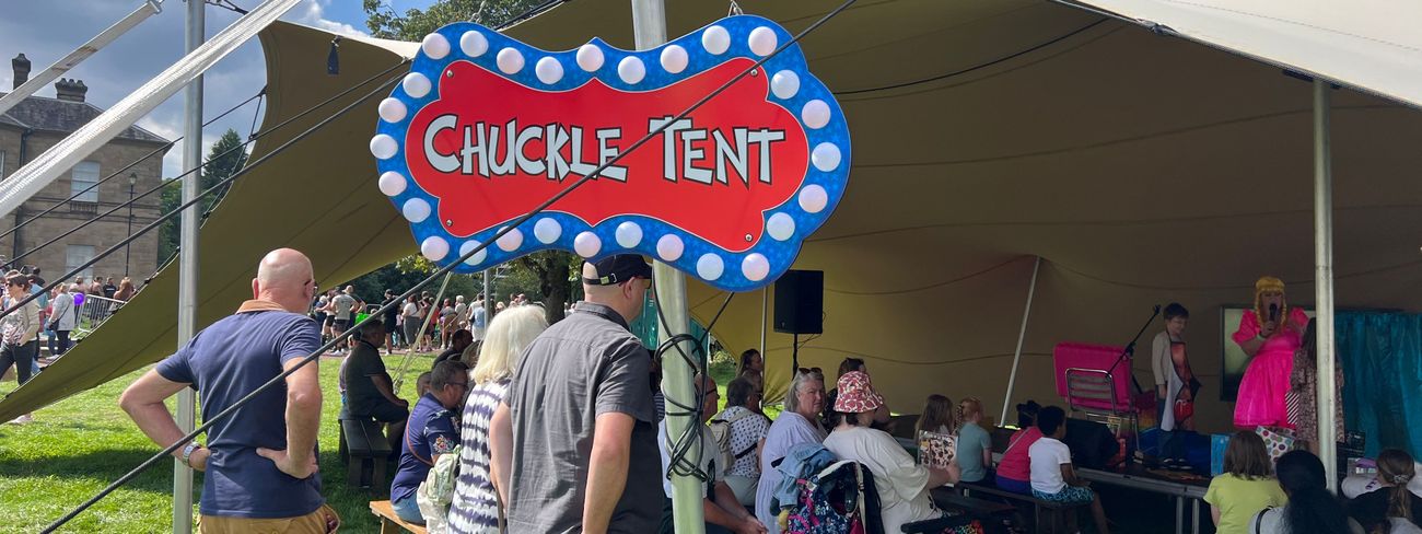 Families and children at a charity fundraising event tent