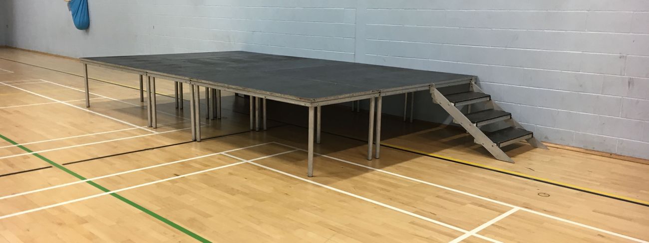 Portable modular stage set up in a school sports hall